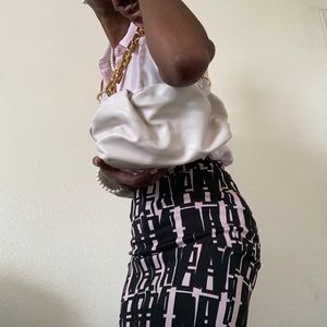 Elegant vegan leather clutch bag with gold chain.